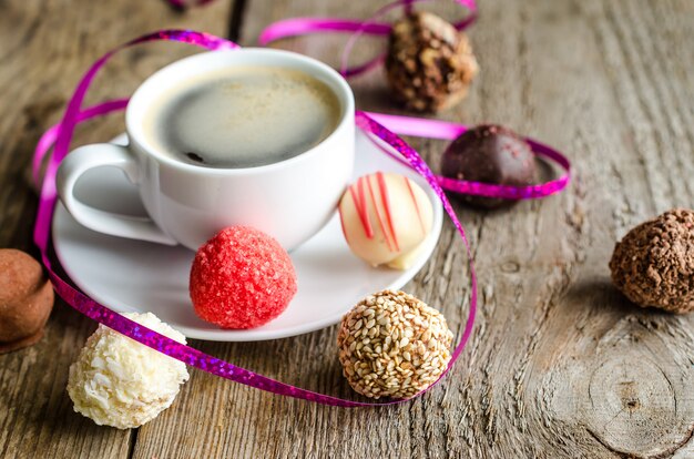 Chocolate candies and cup of coffee