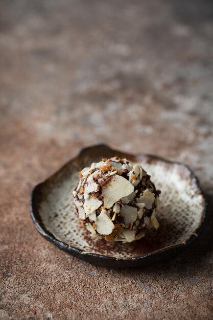 Chocolate candies Delicious dessert Chocolate truffle in waffle crumbs Macro photography of sweet