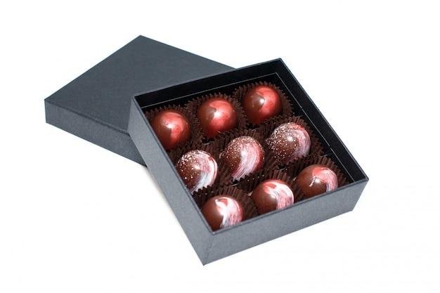 Chocolate candies in giftboxes isolated on white surface. Assorted chocolates confectionery in their gift boxes. Set of colorful chocolate bonbons.