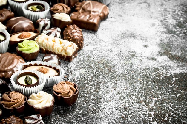 Chocolate candies on rustic background