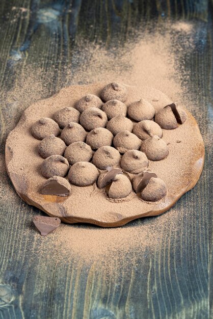 Chocolate candies truffles on a wooden board