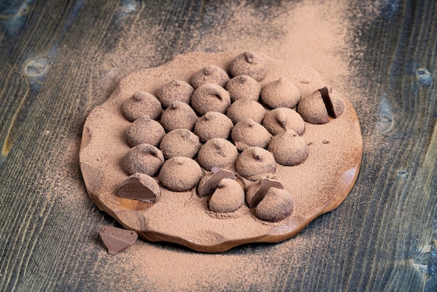 Chocolate candies truffles on a wooden board