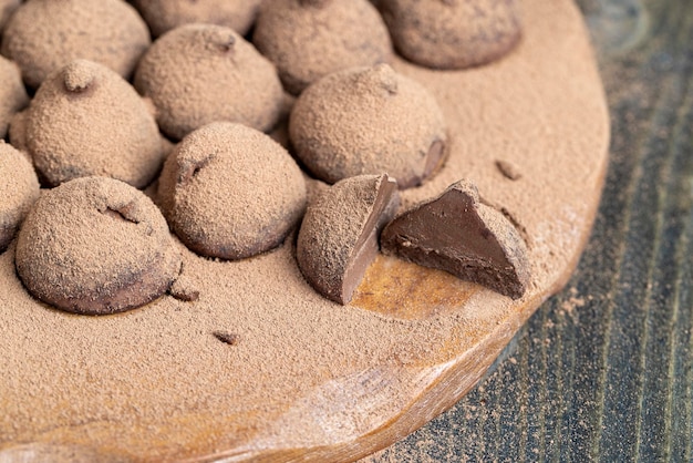 Chocolate candies truffles on a wooden board