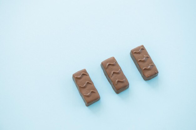 Chocolate candy bar on blue background