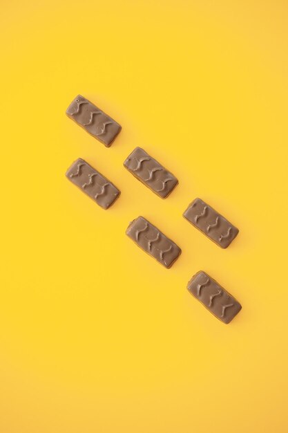 Chocolate candy bar on yellow background