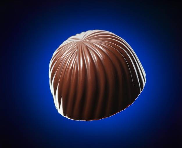 Chocolate candy isolated on dark blue background