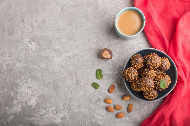 Chocolate caramel ball candies with almonds in a bowl