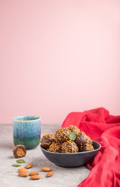 Chocolate caramel ball candies with almonds in a bowl