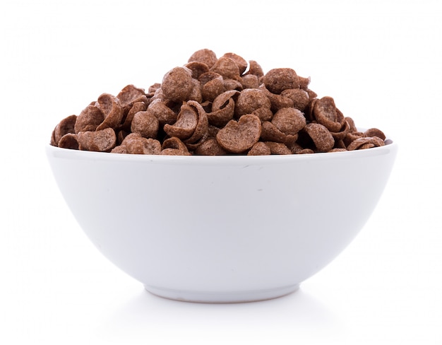 Photo chocolate cereals in white bowl on white background. cornflakes