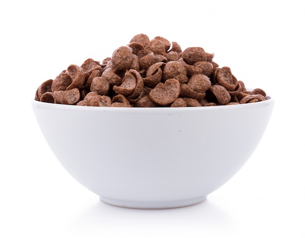 Chocolate cereals in white bowl on white background. Cornflakes