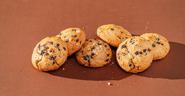 Chocolate chip cookies closeup on brown background