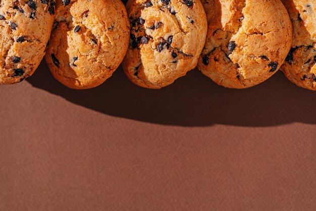 Chocolate chip cookies closeup on brown background