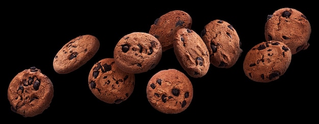 Chocolate chip cookies falling over black background, flying biscuits