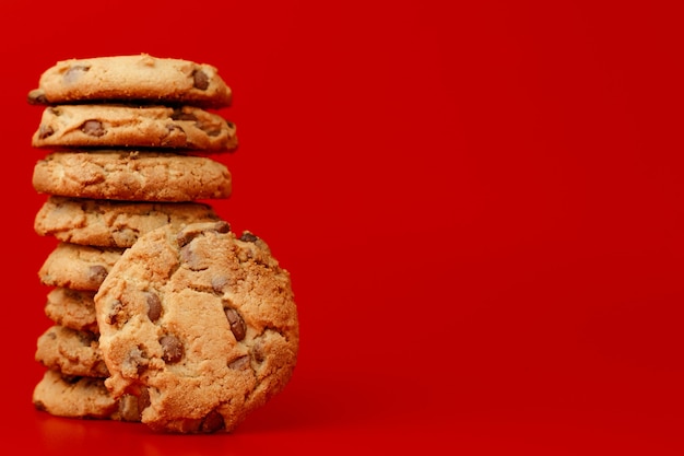 Chocolate chip cookies in stack on red background