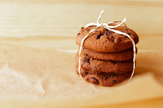 chocolate chip cookies stack on wooden background closeup