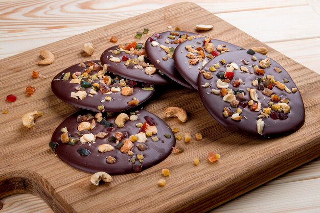 Chocolate chip cookies with cashew nuts and candied fruits on a wooden board Dietary food Healthy food