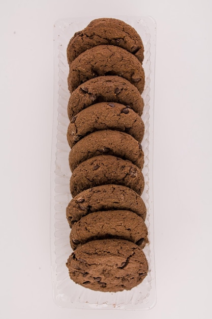 Chocolate chip cookies with chocolate pieces on white background