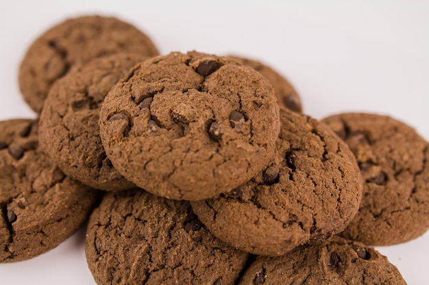 Chocolate chip cookies with chocolate pieces on white background