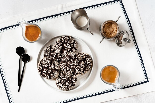 Chocolate chip cookies with sesame seeds on the table with coffee