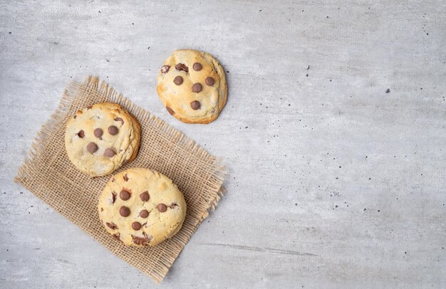 Chocolate chip cookies over wooden table with copy space