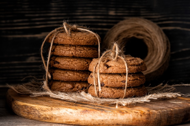 Chocolate chip cookies and on wooden wall. rustic food