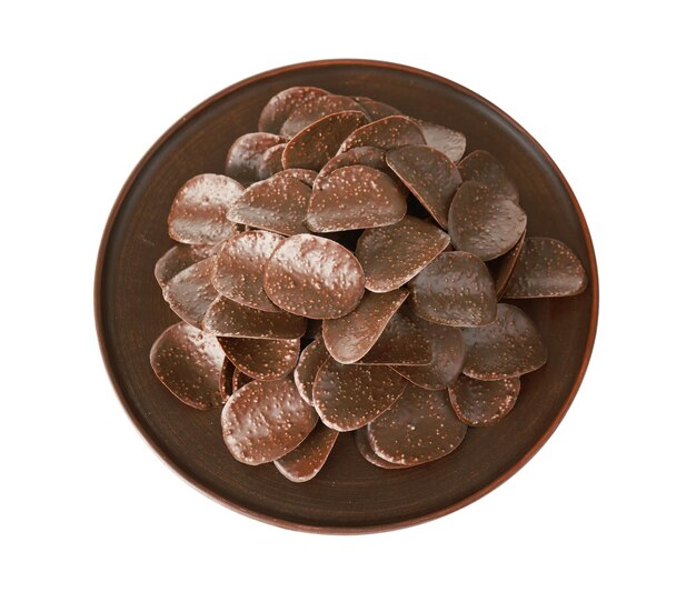 Chocolate chips in brown plate on white background