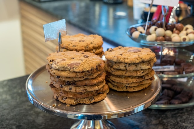 Chocolate chips cookies stacked on aluminium tray at store