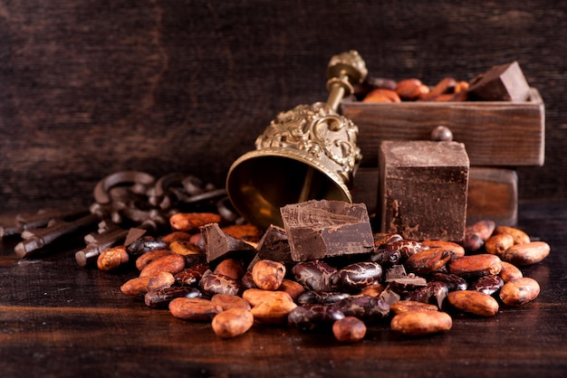 Chocolate and cocoa beans on a wooden background