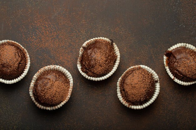 Chocolate and cocoa browny muffins top view on brown rustic