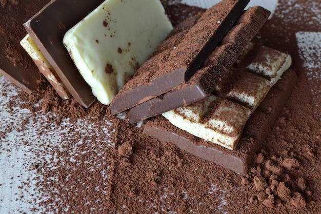 Chocolate and cocoa powder on a white wooden table