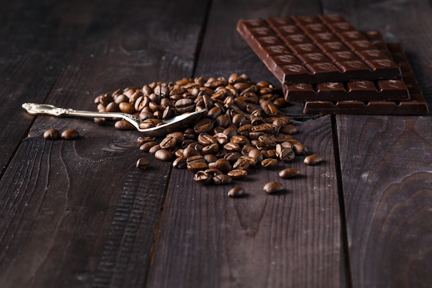 Chocolate and coffee on dark wooden surface