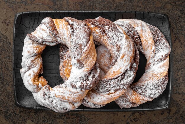 Chocolate cookie rings sprinkled with powdered sugar