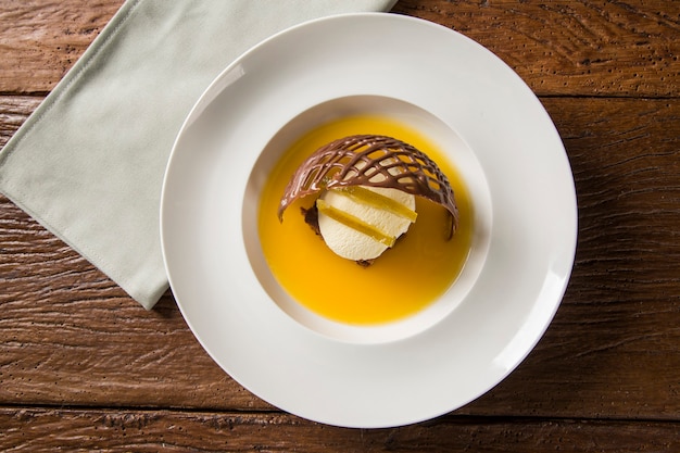 Chocolate cookie with ice cream and orange sauce