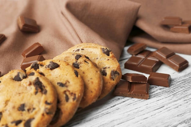 Chocolate cookies on napkin on wooden background