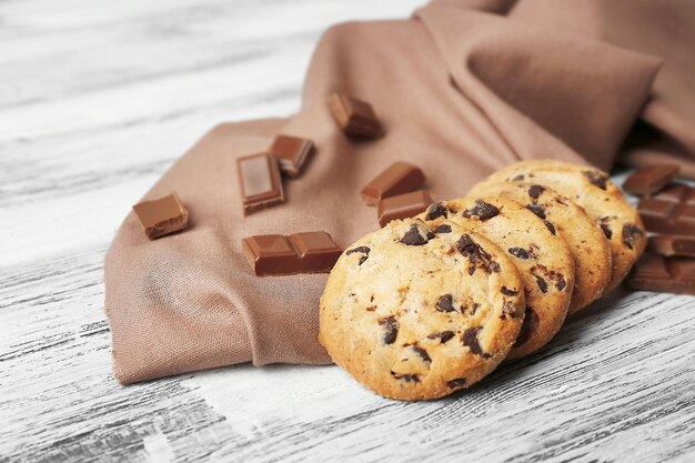 Chocolate cookies on napkin on wooden background