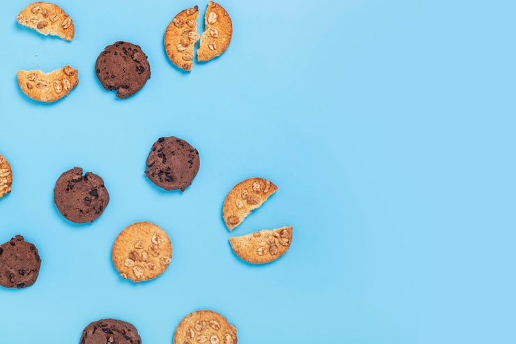 Photo chocolate cookies with chocolate, cookies with nuts on a blue background. top view, flat lay.