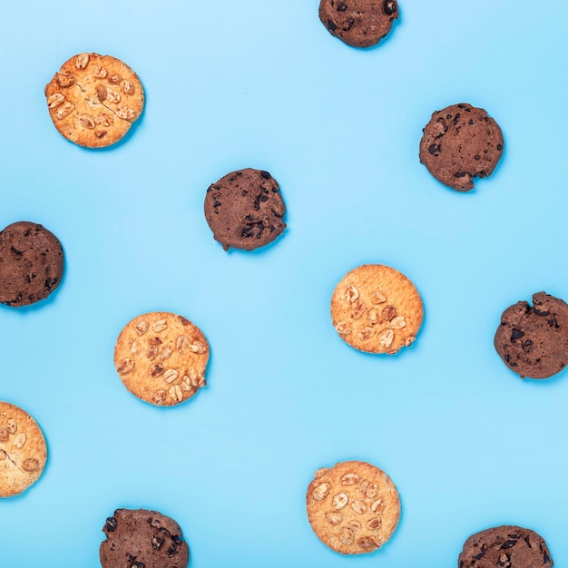 Chocolate cookies with chocolate cookies with nuts on a blue background Top view flat lay