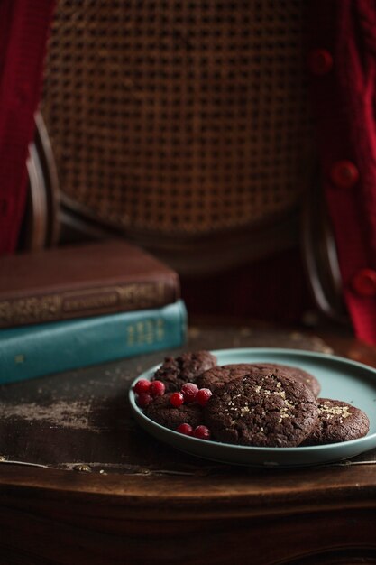 Chocolate cookies with frozen cherries on the plate.