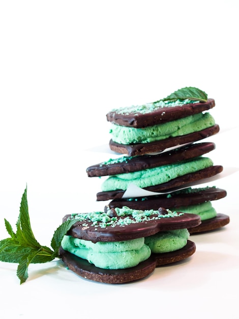 Chocolate cookies with mint filling on white background.