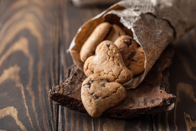 Chocolate cookies on wooden rustic table. Chocolate chip cookies in the shape of a heart. Homemade cookies