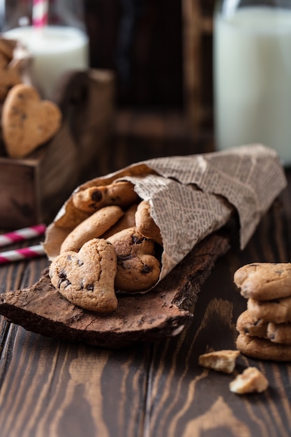 Chocolate cookies on wooden rustic table. Chocolate chip cookies in the shape of a heart. Homemade cookies