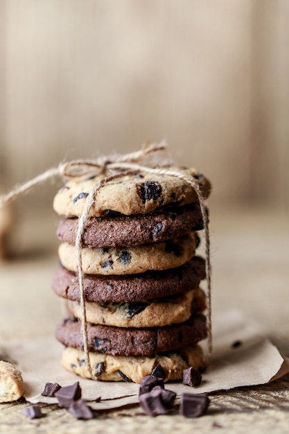 Chocolate cookies on wooden rustic table. Homemade cookies. Stack of tasty chocolate cookies