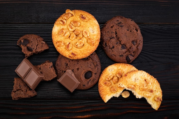 Chocolate cookies on wooden table. Homemade food on wooden background