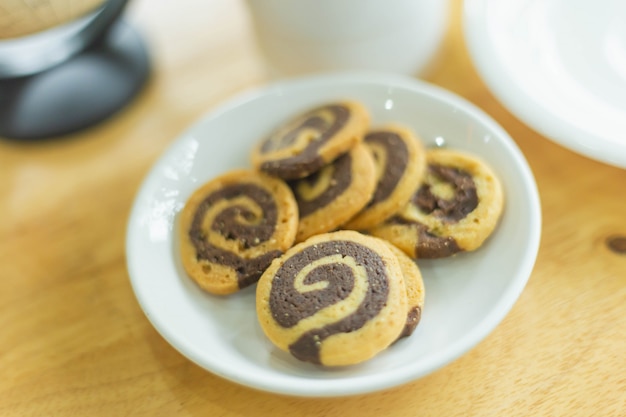 Chocolate cookies on wooden table.