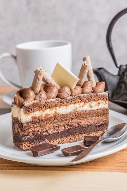 chocolate and cream cake on wooden table