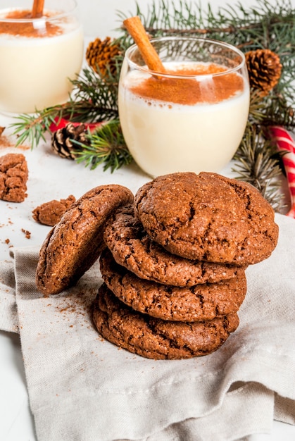 Chocolate Crinkle cookies for Christmas, with eggnog cocktail, candy cane, Christmas tree and holiday decoration, on white , 