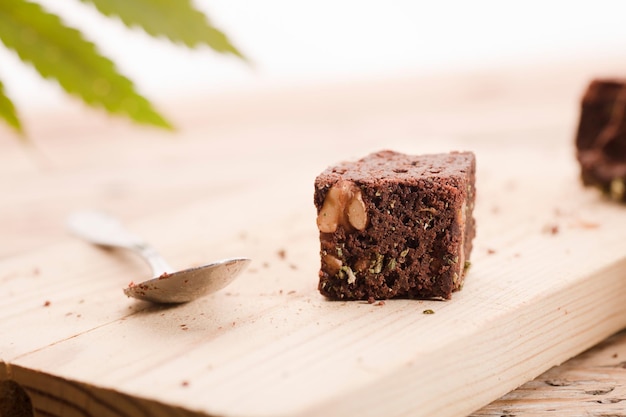 Chocolate cupcake muffins with cannabis budsMarijuana cake on a brown wooden table green marijuana