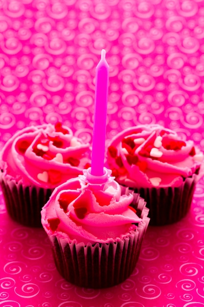 Chocolate cupcake with pink icing decorated for Valentine's Day.