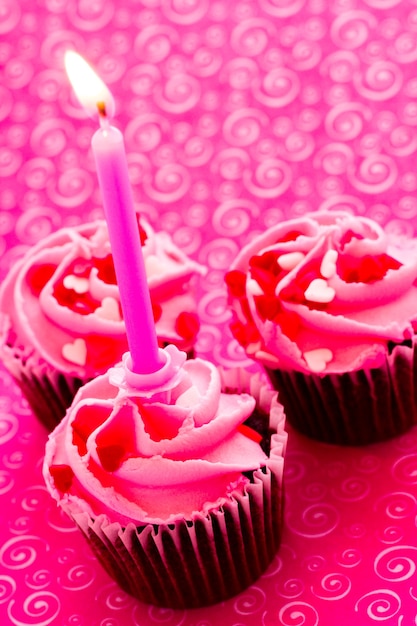 Chocolate cupcake with pink icing decorated for Valentine's Day.