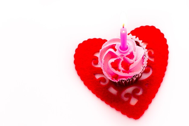 Chocolate cupcake with pink icing decorated for Valentine's Day.